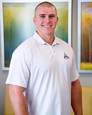 Portrait image of a patient after receiving dental treatment and smiling for their testimonial image.