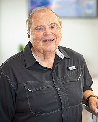 Portrait image of a patient after receiving dental treatment and smiling for their testimonial image.